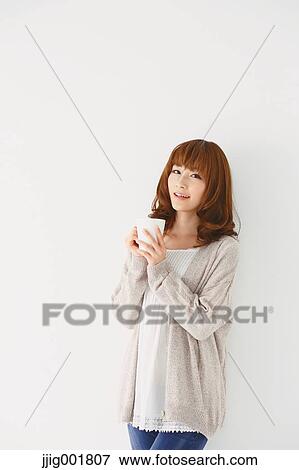 Half length portrait of young Japanese woman against white background View Large Photo Image Stock Photo - Half length portrait of young Japanese woman against white background. Fotosearch