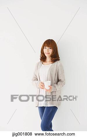 Stock Photo - Half length portrait of young Japanese woman against white background. Fotosearch