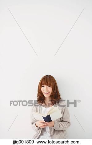 Half length portrait of young Japanese woman against white background View Large Photo Image Stock Photo - Half length portrait of young Japanese woman against white background. Fotosearch