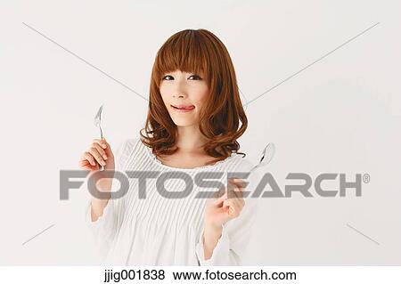 Stock Photo - Half length portrait of young Japanese woman against white background. Fotosearch