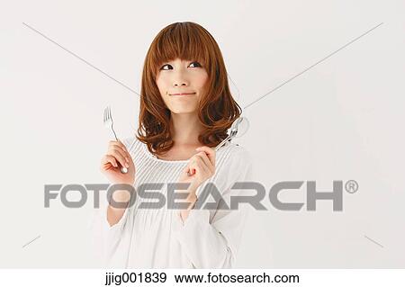 Stock Photo - Half length portrait of young Japanese woman against white background. Fotosearch