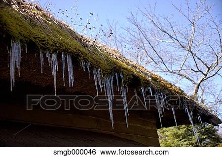 Stock Photograph - Icicles on rooftop. Fotosearch
