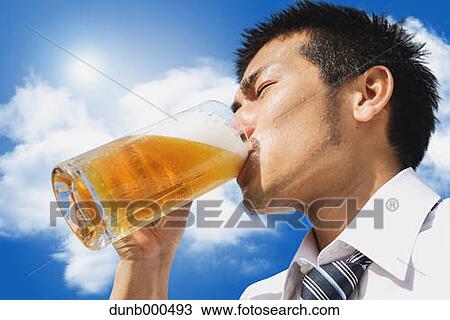Japanese businessman drinking draft beer View Large Photo Image Stock Image - Japanese businessman drinking draft beer. Fotosearch