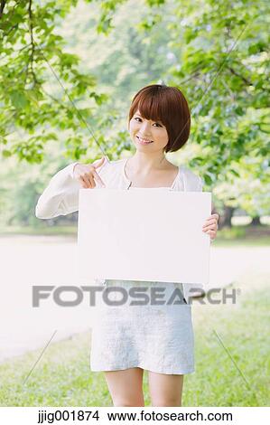 Picture - Portrait of young Japanese woman in a park. Fotosearch