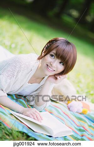 Picture - Portrait of young Japanese woman in a park. Fotosearch