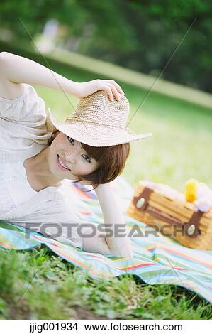 Portrait of young Japanese woman in a park View Large Photo Image Picture - Portrait of young Japanese woman in a park. Fotosearch