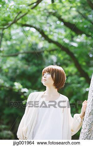 Portrait of young Japanese woman in a park View Large Photo Image Picture - Portrait of young Japanese woman in a park. Fotosearch