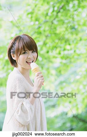 Portrait of young Japanese woman in a park View Large Photo Image Picture - Portrait of young Japanese woman in a park. Fotosearch