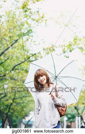 Portrait of young Japanese woman in a park View Large Photo Image Stock Image - Portrait of young Japanese woman in a park. Fotosearch