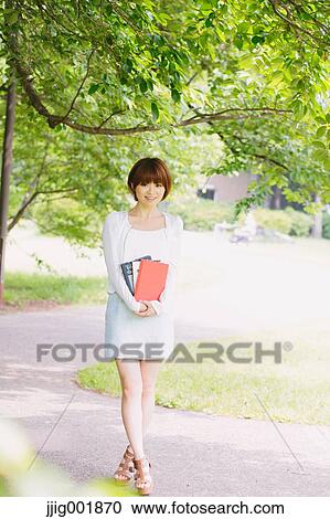 Portrait of young Japanese woman in a park View Large Photo Image Stock Image - Portrait of young Japanese woman in a park. Fotosearch