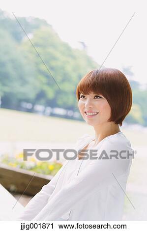 Portrait of young Japanese woman in a park View Large Photo Image Stock Image - Portrait of young Japanese woman in a park. Fotosearch
