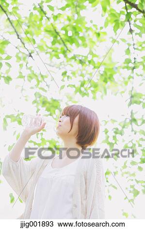 Portrait of young Japanese woman in a park View Large Photo Image Stock Image - Portrait of young Japanese woman in a park. Fotosearch