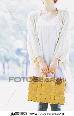Stock Image - Portrait of young Japanese woman in a park. Fotosearch