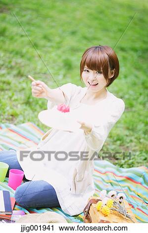 Portrait of young Japanese woman in a park View Large Photo Image Stock Image - Portrait of young Japanese woman in a park. Fotosearch