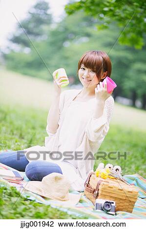 Portrait of young Japanese woman in a park View Large Photo Image Stock Image - Portrait of young Japanese woman in a park. Fotosearch