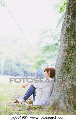 Portrait of young Japanese woman in a park View Large Photo Image Stock Image - Portrait of young Japanese woman in a park. Fotosearch