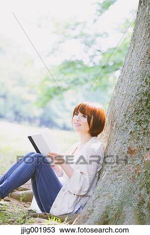 Portrait of young Japanese woman in a park View Large Photo Image Stock Image - Portrait of young Japanese woman in a park. Fotosearch