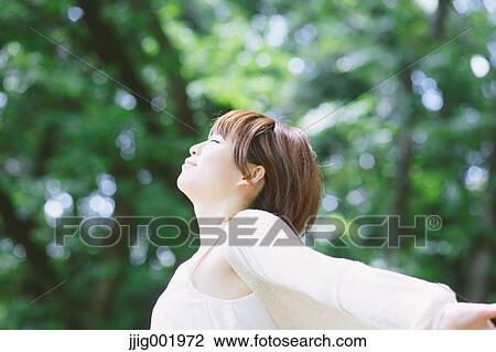 Portrait of young Japanese woman in a park View Large Photo Image Stock Image - Portrait of young Japanese woman in a park. Fotosearch