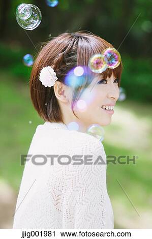 Portrait of young Japanese woman in a park View Large Photo Image Stock Image - Portrait of young Japanese woman in a park. Fotosearch