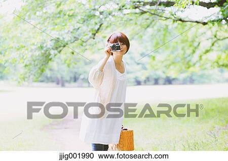 Portrait of young Japanese woman in a park View Large Photo Image Stock Image - Portrait of young Japanese woman in a park. Fotosearch