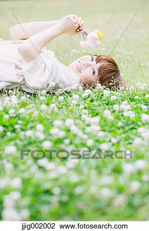 Portrait of young Japanese woman in a park View Large Photo Image Stock Image - Portrait of young Japanese woman in a park. Fotosearch