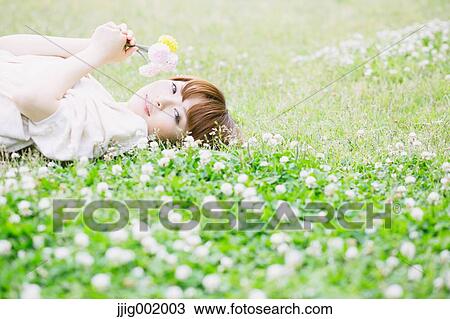 Portrait of young Japanese woman in a park View Large Photo Image Stock Image - Portrait of young Japanese woman in a park. Fotosearch
