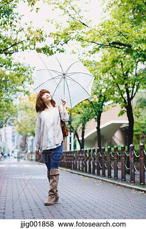 Portrait of young Japanese woman in a park View Large Photo Image Stock Photo - Portrait of young Japanese woman in a park. Fotosearch