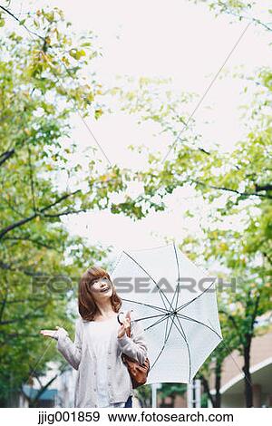 Portrait of young Japanese woman in a park View Large Photo Image Stock Photo - Portrait of young Japanese woman in a park. Fotosearch
