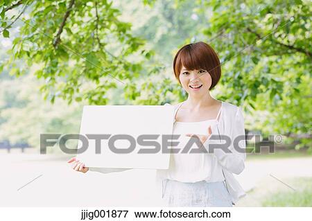 Portrait of young Japanese woman in a park View Large Photo Image Stock Photo - Portrait of young Japanese woman in a park. Fotosearch