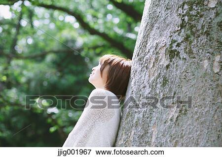 Portrait of young Japanese woman in a park View Large Photo Image Stock Photo - Portrait of young Japanese woman in a park. Fotosearch