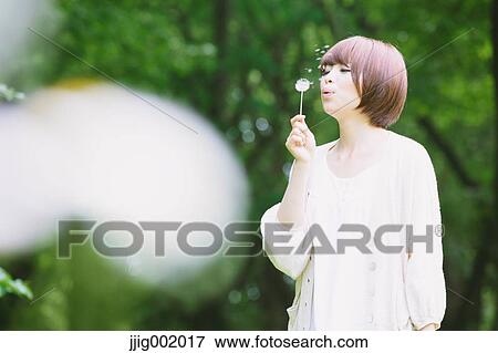 Portrait of young Japanese woman in a park View Large Photo Image Stock Photo - Portrait of young Japanese woman in a park. Fotosearch