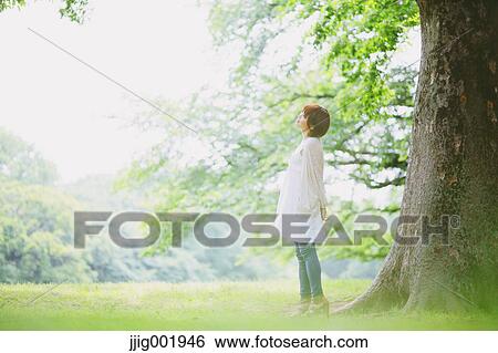 Stock Photograph - Portrait of young Japanese woman in a park. Fotosearch