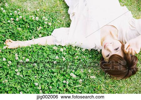 Stock Photograph - Portrait of young Japanese woman in a park. Fotosearch