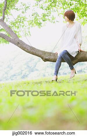 Portrait of young Japanese woman in a park View Large Photo Image Stock Photograph - Portrait of young Japanese woman in a park. Fotosearch