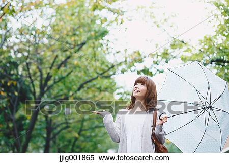 Portrait of young Japanese woman in a park View Large Photo Image Stock Photography - Portrait of young Japanese woman in a park. Fotosearch