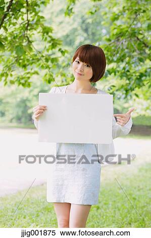 Portrait of young Japanese woman in a park View Large Photo Image Stock Photography - Portrait of young Japanese woman in a park. Fotosearch