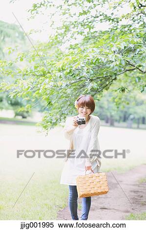 Portrait of young Japanese woman in a park View Large Photo Image Stock Photography - Portrait of young Japanese woman in a park. Fotosearch