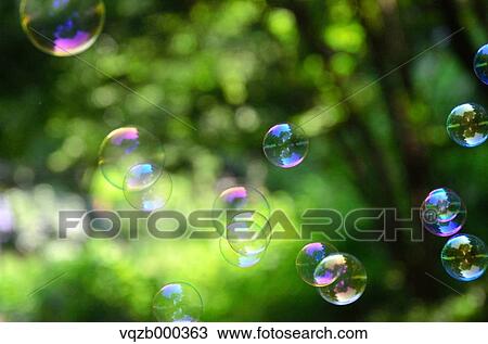 Stock Image - Soap Bubbles In A Park. Fotosearch
