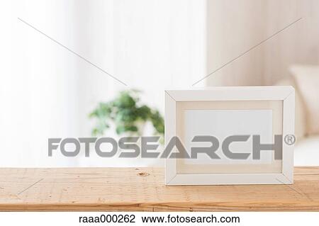 Empty photo frame on wooden table View Large Photo Image Stock Image - Empty photo frame on wooden table. Fotosearch