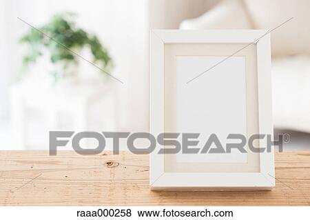 Empty photo frame on wooden table View Large Photo Image Stock Photo - Empty photo frame on wooden table. Fotosearch