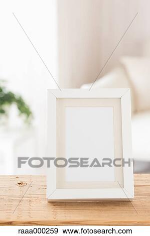 Empty photo frame on wooden table View Large Photo Image Stock Photo - Empty photo frame on wooden table. Fotosearch