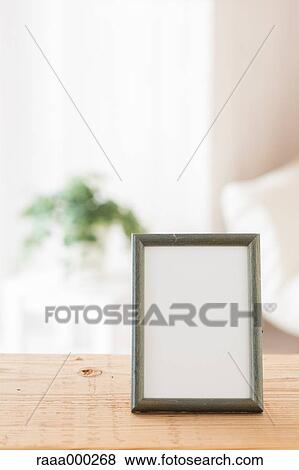 Empty photo frame on wooden table View Large Photo Image Stock Photo - Empty photo frame on wooden table. Fotosearch