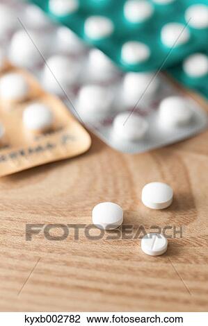 Pills on wooden table View Large Photo Image Stock Image - Pills on wooden table. Fotosearch