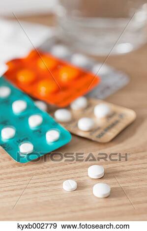 Stock Photo - Pills on wooden table. Fotosearch