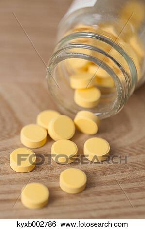 Stock Photograph - Pills on wooden table. Fotosearch