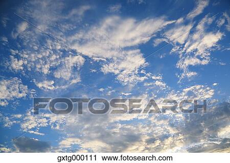 Blue sky with clouds View Large Photo Image Stock Image - Blue sky with clouds. Fotosearch