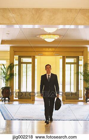Businessman arriving at the hotel View Large Photo Image Stock Photo - Businessman arriving at the hotel. Fotosearch