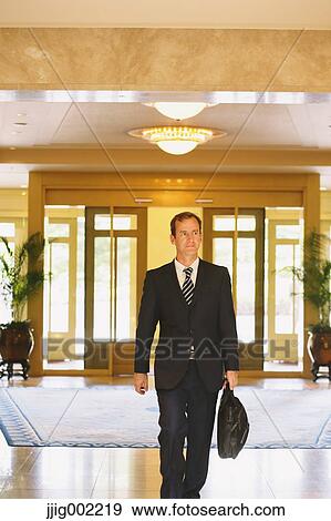 Businessman arriving at the hotel View Large Photo Image Stock Photo - Businessman arriving at the hotel. Fotosearch