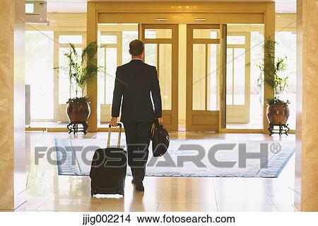 Businessman leaving hotel View Large Photo Image Picture - Businessman leaving hotel. Fotosearch