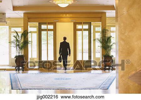 Businessman leaving hotel View Large Photo Image Stock Photograph - Businessman leaving hotel. Fotosearch